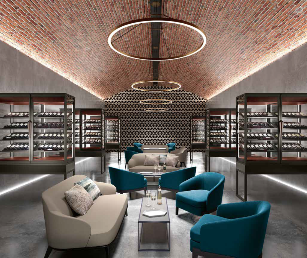 Rows of green and grey arm chairs and sofas facing one another down a long room. BLUE wine cabinets in the background show casing wine