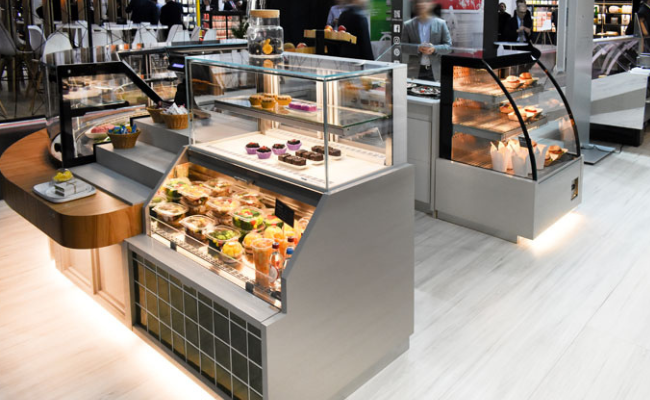 Grab and Go Displays, Open Air Merchandisers. One for pastry in foreground, one refrigerated grab and go for prepared meals in background.